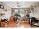 Functional home office features hardwood floors, natural light, and a ceiling fan to enhance air circulation at 7954 S Franklin Ct, Centennial, CO 80122