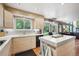 Contemporary kitchen showcasing sleek countertops, stainless steel appliances, and a breakfast bar overlooking the backyard at 7954 S Franklin Ct, Centennial, CO 80122