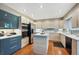 Well-lit kitchen featuring wood-grain cabinets, stainless steel appliances, and a center island for food preparation at 7954 S Franklin Ct, Centennial, CO 80122