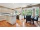 Bright kitchen with an island, modern cabinetry, stainless steel appliances, and an adjacent dining area with bay windows at 7954 S Franklin Ct, Centennial, CO 80122