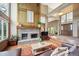 Inviting living room featuring a brick fireplace, high ceilings, and an open entryway for seamless flow at 7954 S Franklin Ct, Centennial, CO 80122