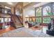 Elegant entryway with staircase leading to the upper level, and a view into the spacious living room with large windows at 7954 S Franklin Ct, Centennial, CO 80122