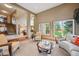 Open-concept living area with staircase, large windows, and comfortable seating, with views of the backyard at 7954 S Franklin Ct, Centennial, CO 80122