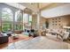 Bright living room with tall ceilings, large windows, a fireplace, and comfortable seating arrangements at 7954 S Franklin Ct, Centennial, CO 80122