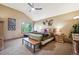 Spacious main bedroom featuring a vaulted ceiling, ceiling fan, and an inviting seating area near a window at 7954 S Franklin Ct, Centennial, CO 80122