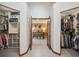 View of main bedroom through walk-in closet, featuring a vaulted ceiling and cozy design at 7954 S Franklin Ct, Centennial, CO 80122