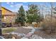 A cozy backyard fire pit area with stone accents and wood seating, perfect for outdoor gatherings at 16541 W 48Th Ln, Golden, CO 80403