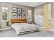 Bright main bedroom featuring a wood headboard and modern decor at 16541 W 48Th Ln, Golden, CO 80403