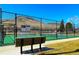 Well-maintained pickleball court with surrounding fencing, situated against a backdrop of scenic hills at 16541 W 48Th Ln, Golden, CO 80403