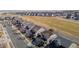 Aerial view of suburban neighborhood featuring green spaces and numerous single Gathering homes at 16404 E 117Th Ave, Commerce City, CO 80022