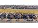 Aerial view of a neighborhood with a park or green space and many houses at 16404 E 117Th Ave, Commerce City, CO 80022