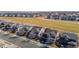 Aerial view of single-Gathering homes backing onto community green space with walking path at 16404 E 117Th Ave, Commerce City, CO 80022