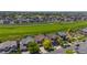 Real estate aerial view showing houses along green space, offering privacy in a suburban setting at 16404 E 117Th Ave, Commerce City, CO 80022