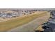 Overhead view of neighborhood with a large green space and walking path at 16404 E 117Th Ave, Commerce City, CO 80022