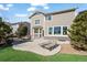 Backyard with concrete patio, green space and seating area. Back of house in view at 16404 E 117Th Ave, Commerce City, CO 80022