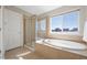 Bright bathroom featuring a soaking tub, a glass shower, and a large window at 16404 E 117Th Ave, Commerce City, CO 80022