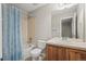 Clean bathroom with shower over tub and wood vanity at 16404 E 117Th Ave, Commerce City, CO 80022