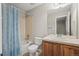 Bathroom featuring a shower and tub, wood vanity, and a large mirror at 16404 E 117Th Ave, Commerce City, CO 80022