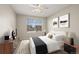 Comfortable bedroom featuring a ceiling fan, plush bed, dresser, and bedside tables at 16404 E 117Th Ave, Commerce City, CO 80022