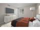 Modern bedroom with a TV, plush bed, and a white dresser at 16404 E 117Th Ave, Commerce City, CO 80022
