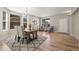 Dining room with hardwood flooring, modern rug, and ample natural light at 16404 E 117Th Ave, Commerce City, CO 80022