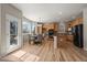 Eat-in kitchen boasts natural wood cabinets, stainless steel appliances, a breakfast bar, and a sunlit breakfast nook at 16404 E 117Th Ave, Commerce City, CO 80022