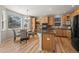 Kitchen features natural wood cabinets, stainless steel appliances, granite counters, and a breakfast bar at 16404 E 117Th Ave, Commerce City, CO 80022