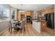 Kitchen features natural wood cabinets, stainless steel appliances, granite counters, and a breakfast bar at 16404 E 117Th Ave, Commerce City, CO 80022