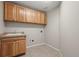 Functional laundry room with cabinetry, a sink, and laundry hookups at 16404 E 117Th Ave, Commerce City, CO 80022