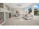 Spacious living room with fireplace, plush carpeting, and large windows at 16404 E 117Th Ave, Commerce City, CO 80022