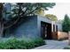 Contemporary home featuring dark brick exterior and lush landscaping at 2627 W 40Th Ave, Denver, CO 80211