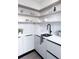 Well-organized kitchen area with white countertops, subway tile backsplash, and open shelving at 2627 W 40Th Ave, Denver, CO 80211