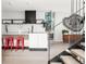 Modern kitchen with island, red stools, open shelving, marble backsplash and view to the entry at 2627 W 40Th Ave, Denver, CO 80211