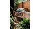 Outdoor kitchen with grill and countertop surrounded by lush greenery and wood fence at 2627 W 40Th Ave, Denver, CO 80211