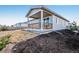 Backyard view of deck, covered patio, and fresh landscaping at 4128 Castle Vista Ln, Castle Rock, CO 80104