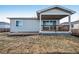 View of backyard with deck, covered patio, and partial landscaping at 4128 Castle Vista Ln, Castle Rock, CO 80104