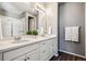 Bright bathroom featuring double sinks with quartz counters and modern fixtures, plus glass shower at 4128 Castle Vista Ln, Castle Rock, CO 80104