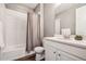 Bright bathroom features a shower-tub combo, white vanity with granite counters, and wood-look floors at 4128 Castle Vista Ln, Castle Rock, CO 80104