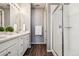 Bright bathroom featuring double sinks with quartz counters and modern fixtures, plus glass shower at 4128 Castle Vista Ln, Castle Rock, CO 80104