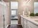 Bright bathroom featuring double sinks with quartz counters and modern fixtures, plus glass shower and neutral bedroom at 4128 Castle Vista Ln, Castle Rock, CO 80104