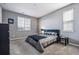 Cozy bedroom featuring neutral walls, carpet, and a comfortable bed with ample natural light from the window at 4128 Castle Vista Ln, Castle Rock, CO 80104