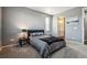 Neutral bedroom featuring neutral walls, carpet, and a comfortable bed with an ensuite bathroom at 4128 Castle Vista Ln, Castle Rock, CO 80104