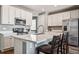 Modern kitchen featuring stainless steel appliances, white cabinets, and a quartz countertops at 4128 Castle Vista Ln, Castle Rock, CO 80104