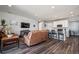 Open concept living room flowing into a modern kitchen with stainless steel appliances and hardwood floors at 4128 Castle Vista Ln, Castle Rock, CO 80104