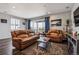 Inviting living room featuring hardwood floors, recessed lighting, and a sliding glass door with views at 4128 Castle Vista Ln, Castle Rock, CO 80104