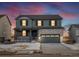 Two-story house with gray siding, stone accents, and a two-car garage at 23998 E Atlantic Pl, Aurora, CO 80018