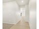 Light-filled hallway with light brown laminate flooring and carpeted areas at 23998 E Atlantic Pl, Aurora, CO 80018