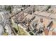 Aerial view of townhome roofs with brick chimneys and patios at 14252 E Radcliff Cir, Aurora, CO 80015