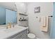 Bathroom featuring a vanity with white countertop, brass fixtures, and decorative mirror at 14252 E Radcliff Cir, Aurora, CO 80015