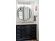 Bathroom featuring a modern vanity with marble countertop, updated light fixture, and round mirror at 14252 E Radcliff Cir, Aurora, CO 80015